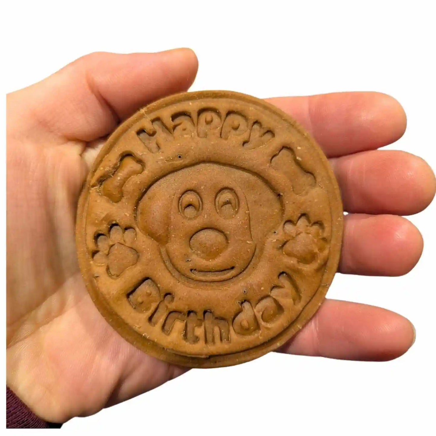 Cookie with 'Happy Birthday' and a cartoon face on a hand