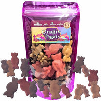 Purple bag of 'Quality Treats' dog biscuits with various shapes and colors on a white background