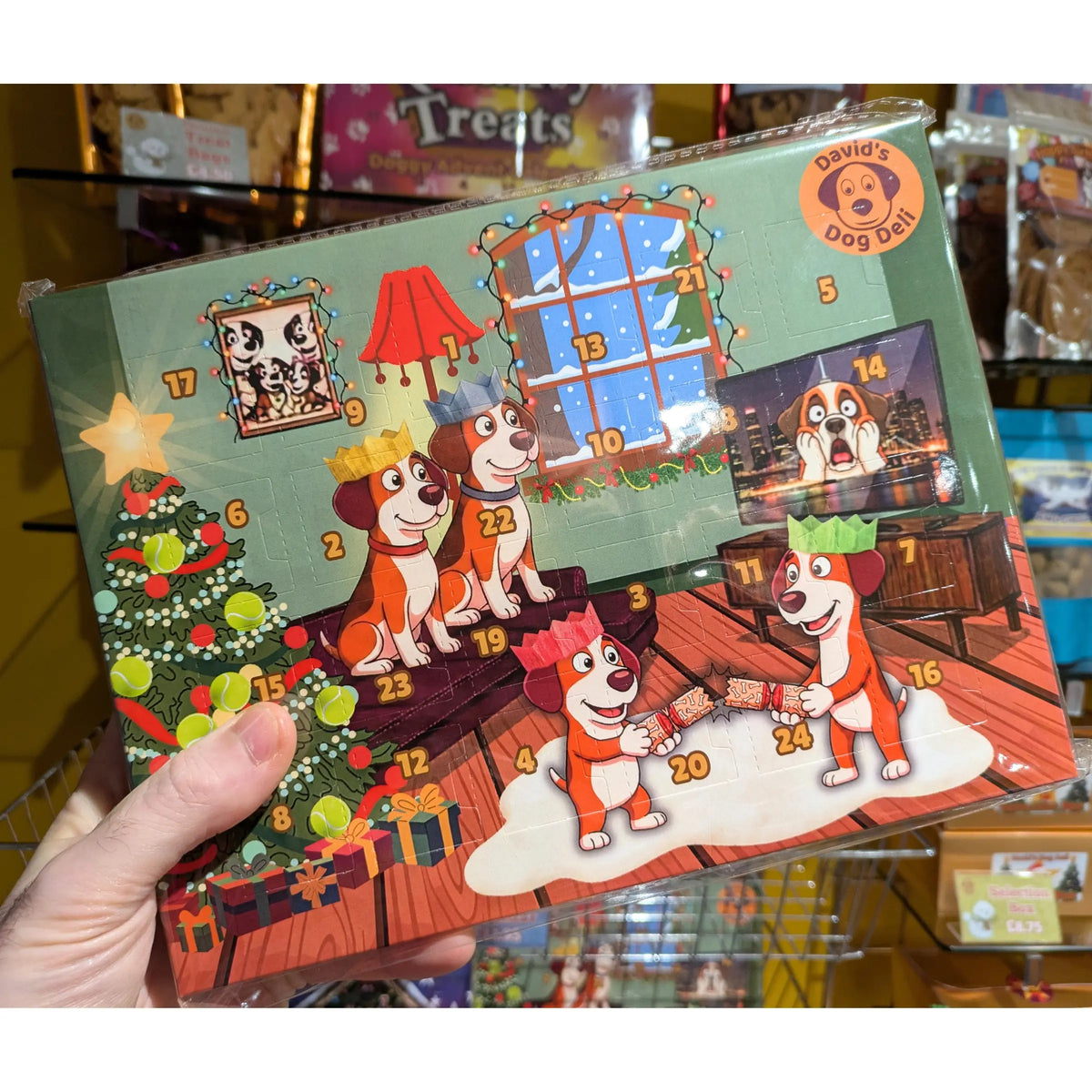 Image shows an Advent Calendar for dogs, with a doggy family scene, branded David's Dog Deli