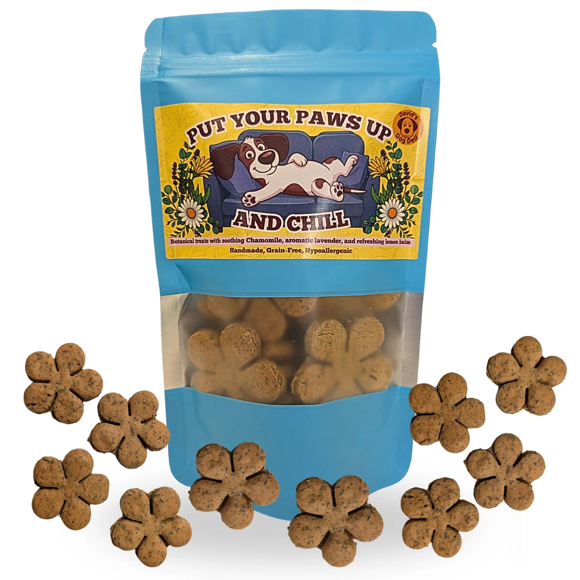 A blue stand-up pouch of dog treats with a clear window showing brown flower-shaped treats inside, surrounded by several loose flower-shaped treats on a white background. The front label reads 'PUT YOUR PAWS UP AND CHILL' with an illustration of a dog on a couch.