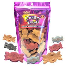 A bag of dog treats with sweetie-shaped pieces visible through a clear front window, surrounded by several loose sweetie-shaped treats in different colors on a white background.