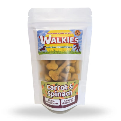 A stand-up pouch of Walkies dog treats, specifically Carrot & Spinach flavor. The white resealable pouch has a clear window showing the bone-shaped treats inside, with colorful labels on the front.