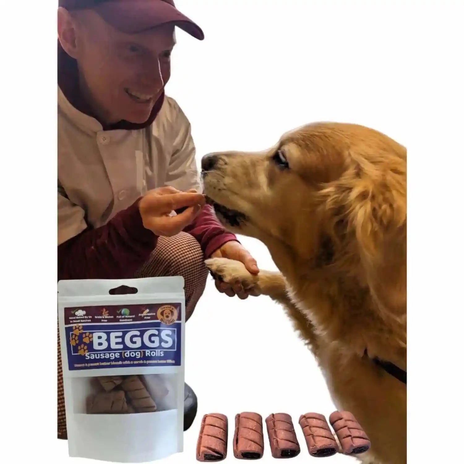 Man feeding a dog a treat with a package of Beggs Sausage Dog Rolls in the foreground.